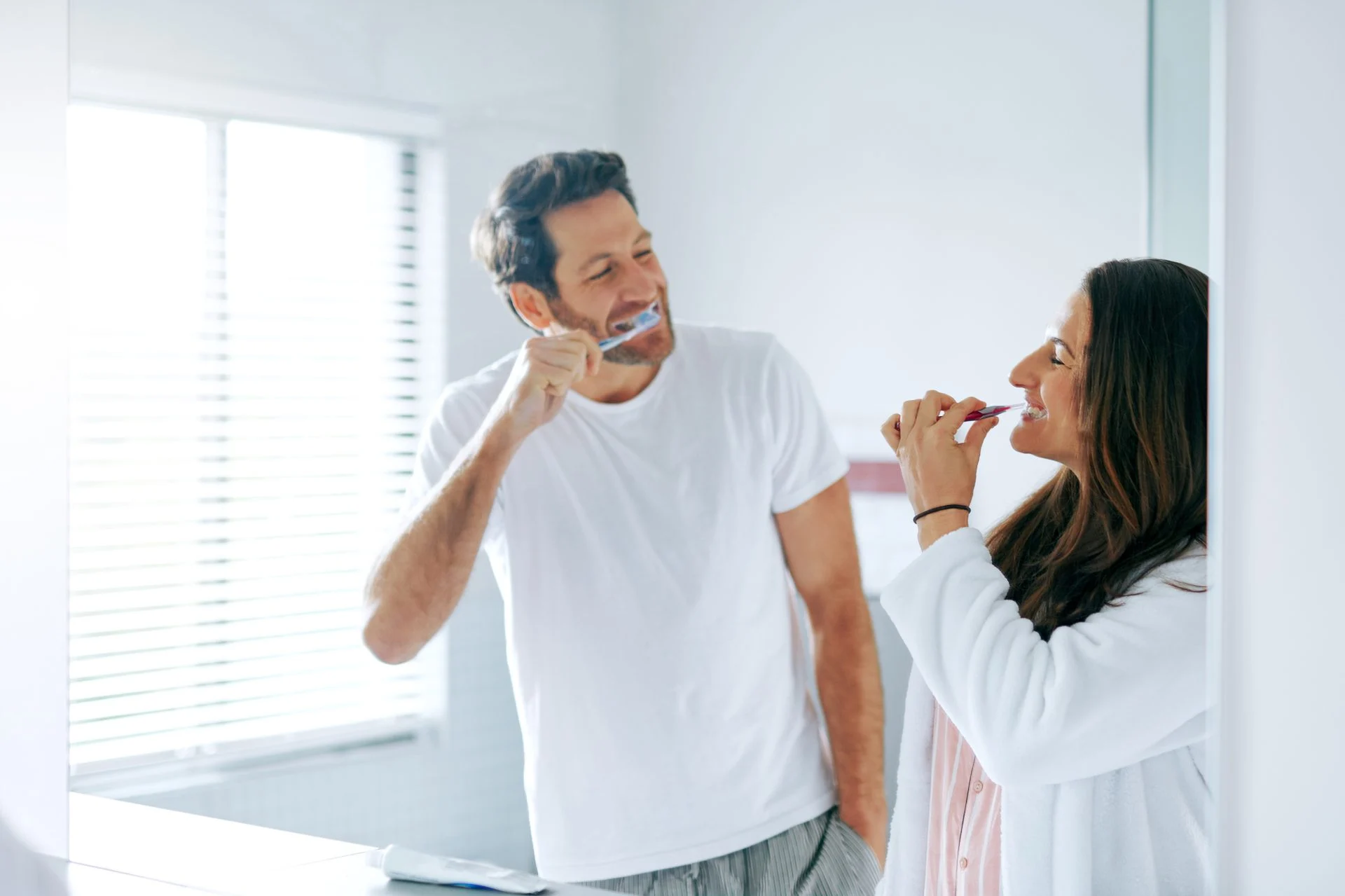 brushing-teeth-happy-toothbrush-with-couple-bathroom-oral-hygiene-breath-cleaning-self-care-wellness-dental-with-man-woman-home-gum-treatment-toothpaste-health